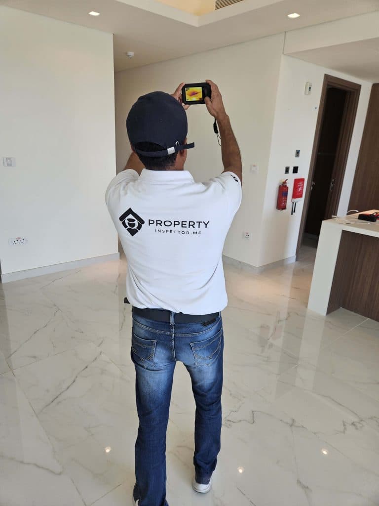 Inspector measuring AC airflow and temperature